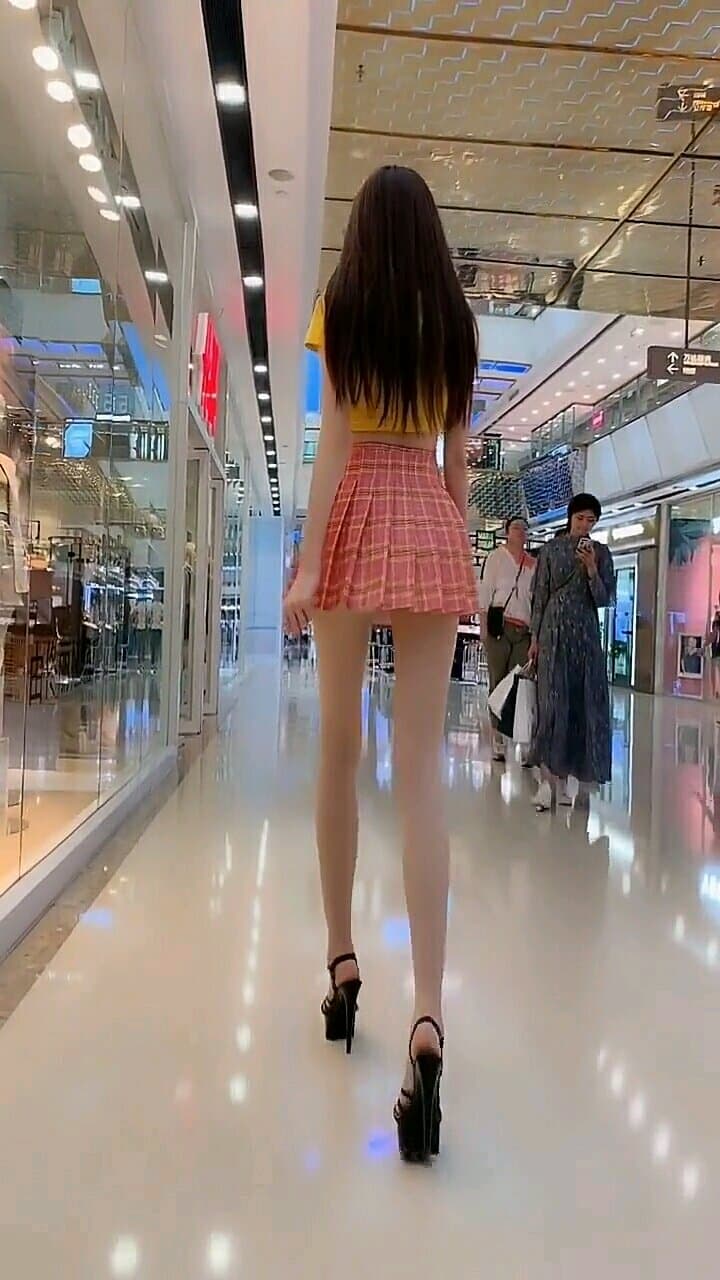 Close-up of stocking-clad leg with sheen, heel arched and toes curled provocatively against fabric