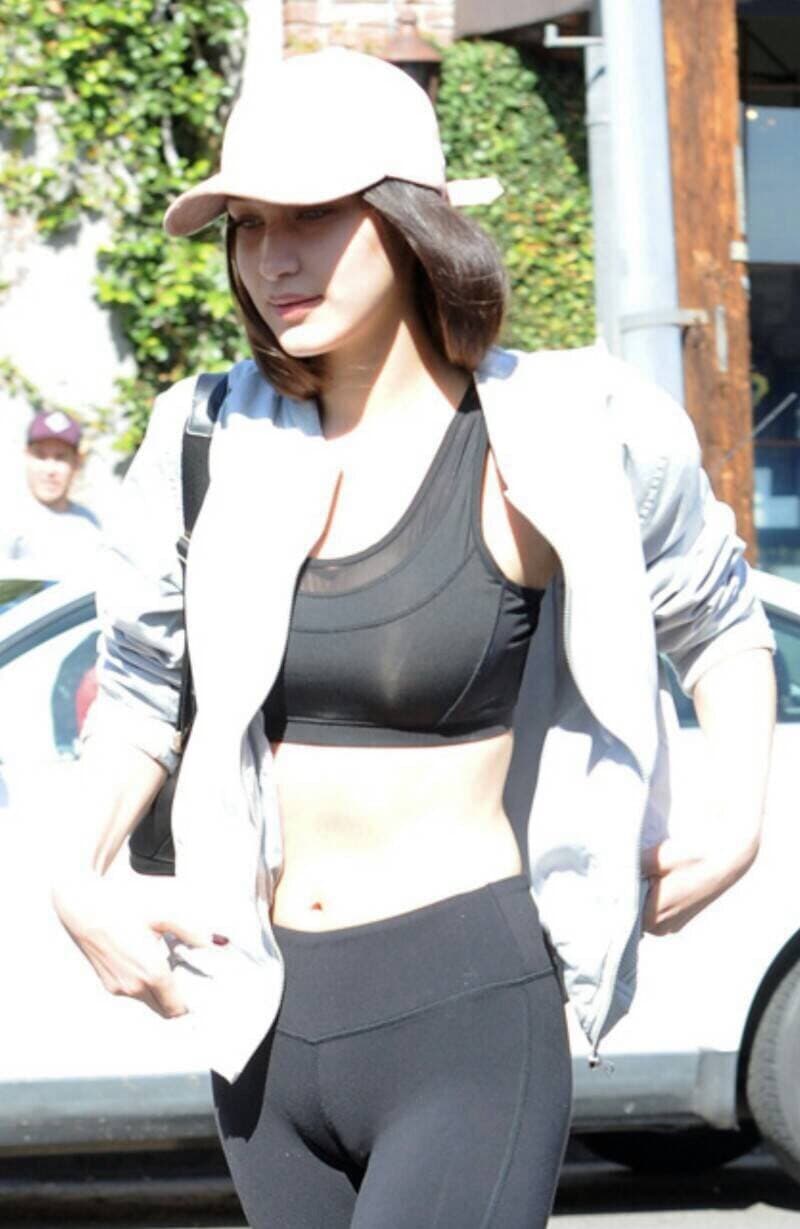 Cotton socks peeking from gray jogging pants, ankle exposed and toes slightly flexed in soft fabric