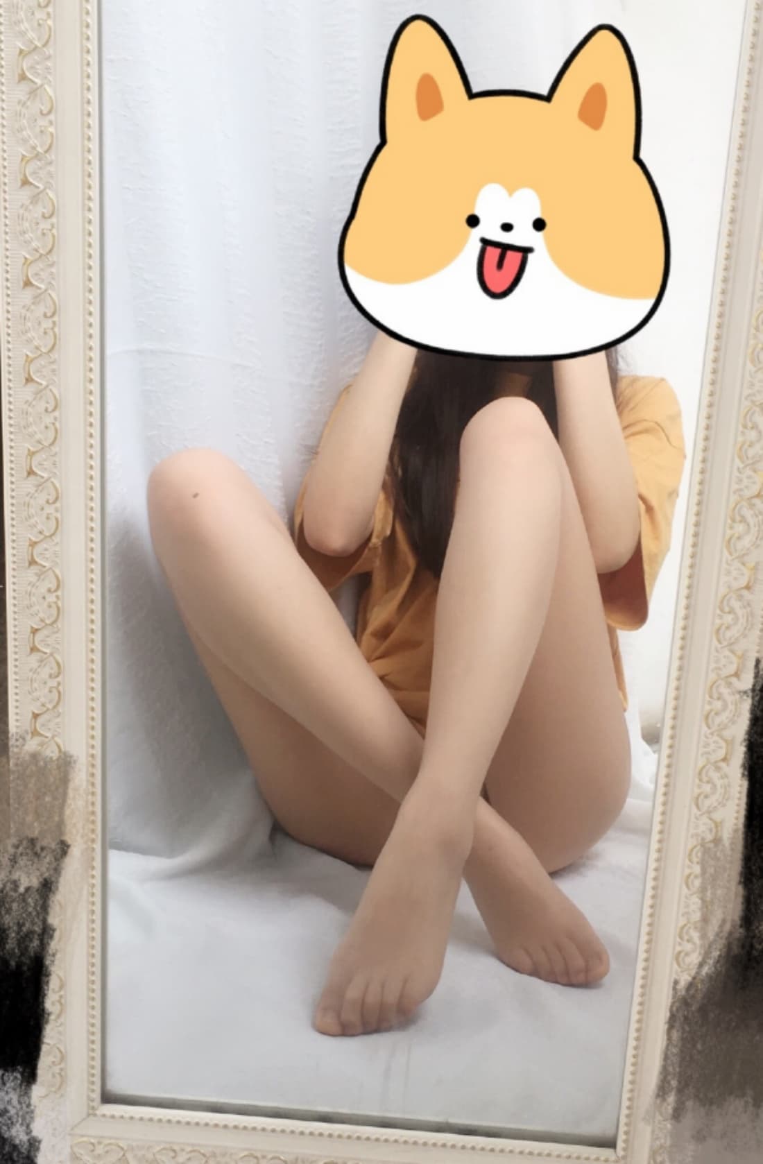 Sunlit bare feet stretched on a windowsill next to a pair of casually pushed-down socks