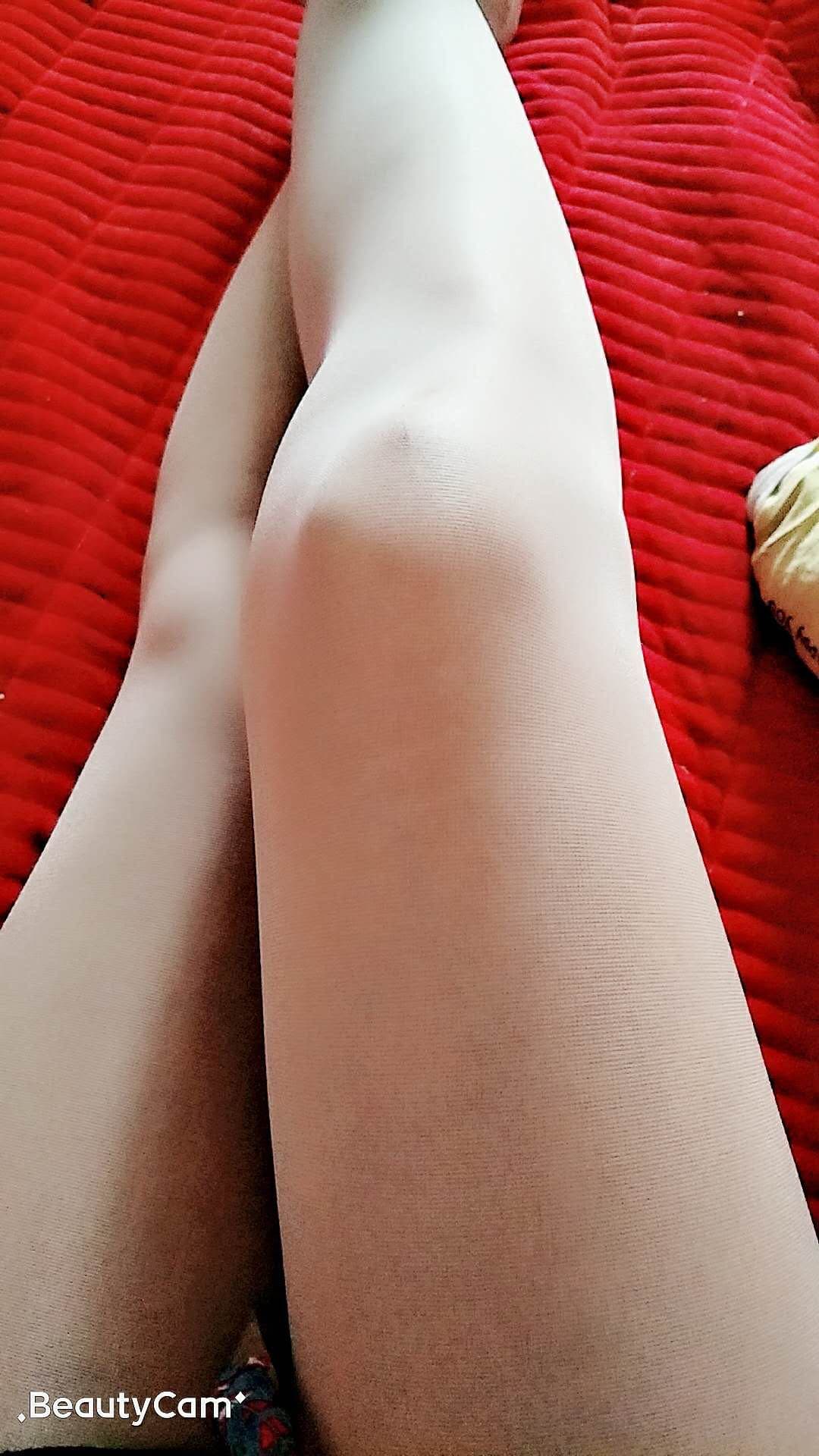 Newcomer’s shy foot wearing slightly oversized cotton sock, toes curling as fabric bunches at ankle