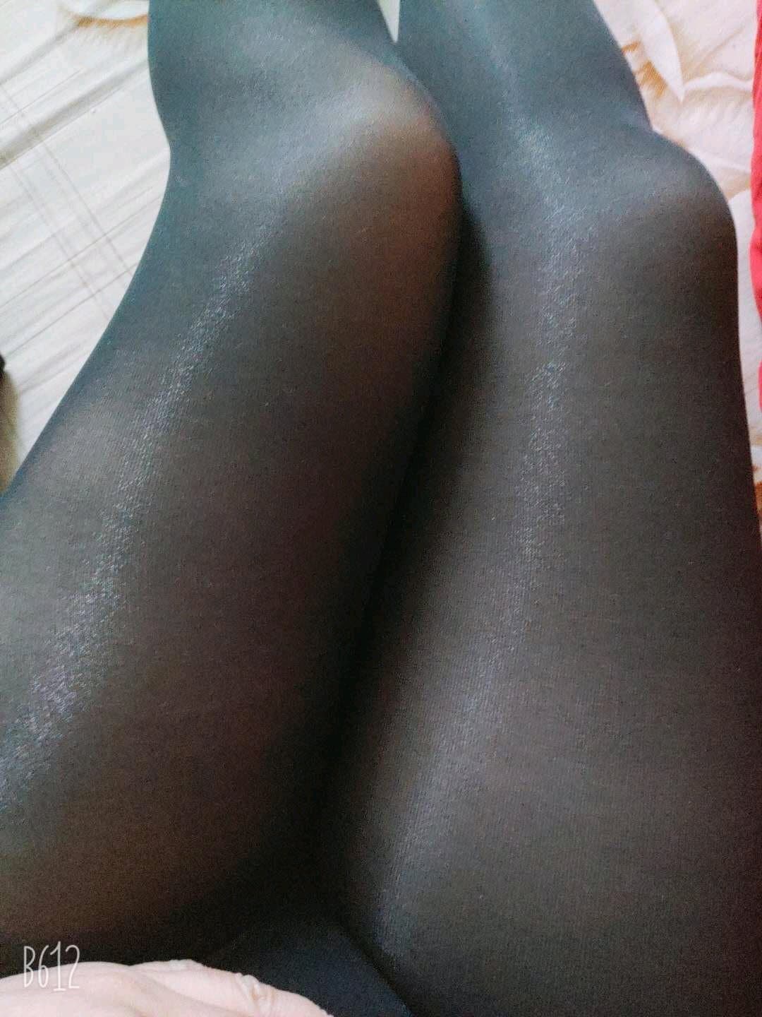 Close framing of thick thighs in sheer stockings, fabric hugging curves with visible sheen and texture detail