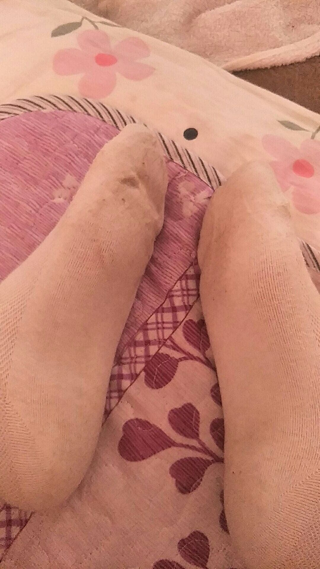 Close-up of a sweaty foot encased in clingy nylon, highlighting shiny skin and defined toes