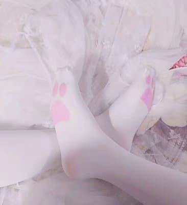 Teasing shot of a foot slipping out of a sheer stocking, toes curled and sole softly lit
