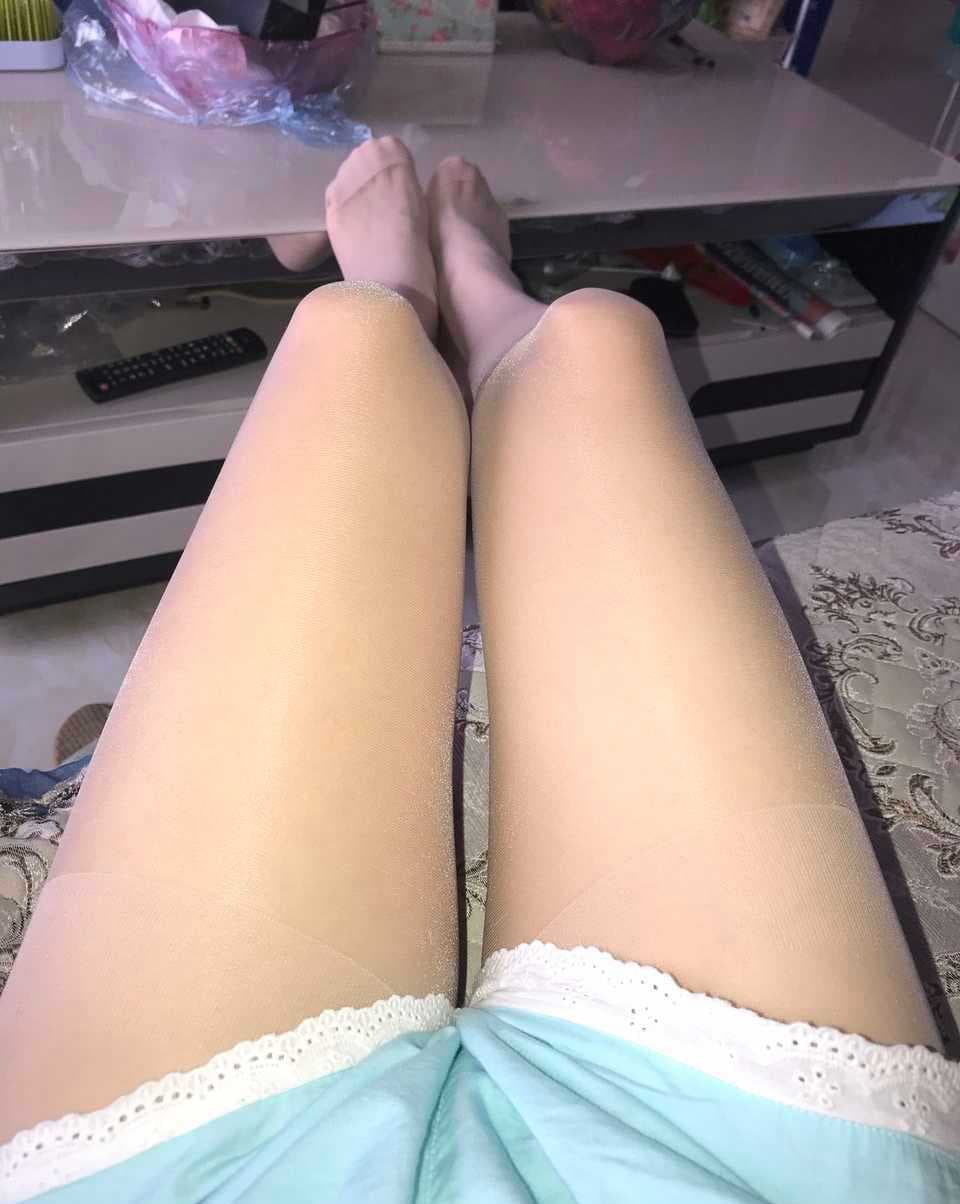 Teasing foot close-up with glossy nylon and bare heel, inviting viewers to rate texture and pose