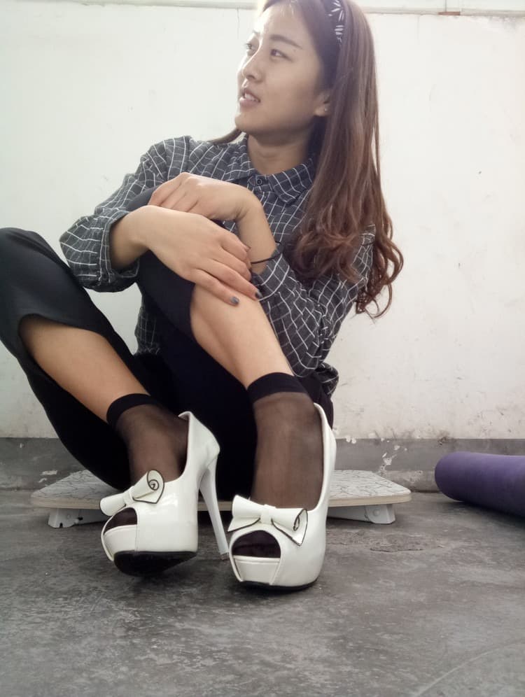 Cozy scene of feet tucked in soft cotton socks, toes subtly pressing through fabric in a relaxed pose