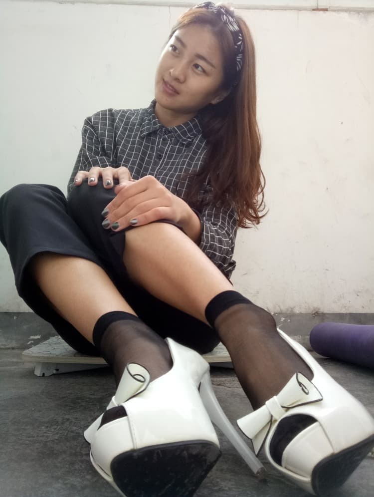 Close-up of a bare arch and heel peeking from a blanket, soft lighting accentuating natural skin texture