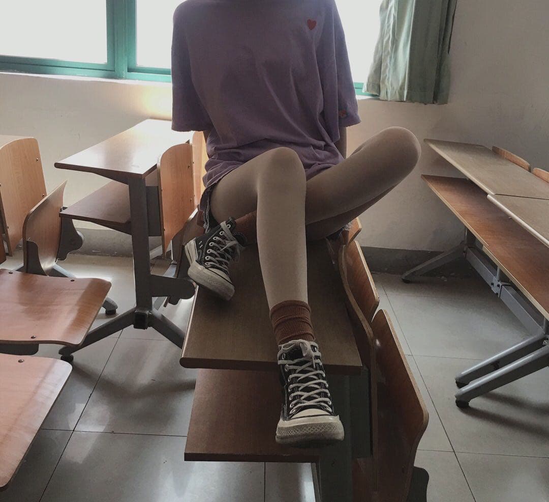 Adult-styled campus stairwell shot with stockings rolled down and a bare foot on the step