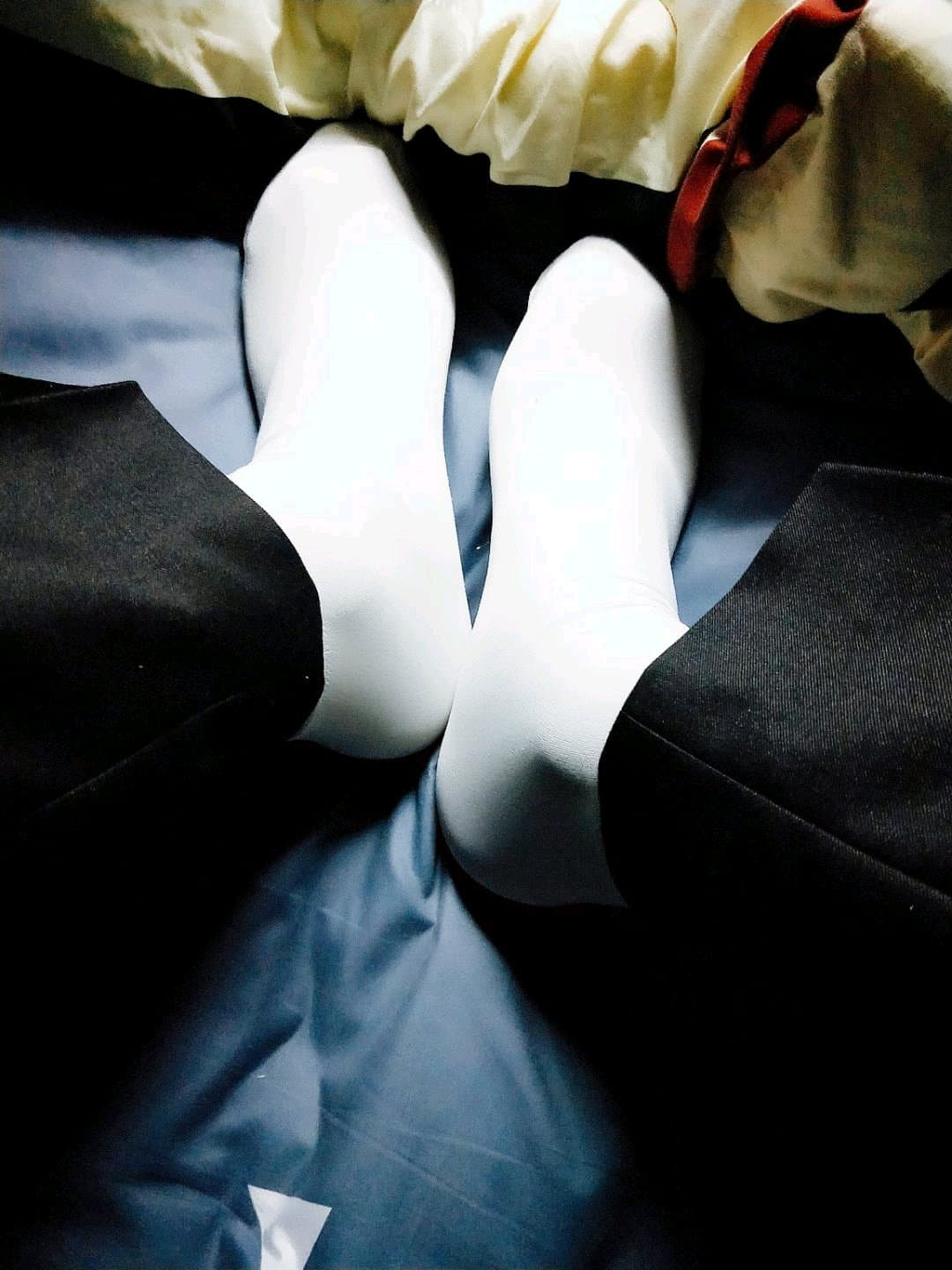 stockinged foot peeking from dress hem