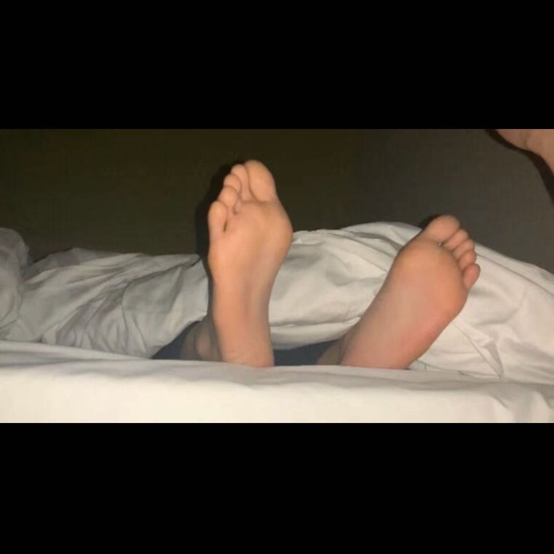 Gentle hands caressing a girlfriend's stocking-clad foot, capturing a private, intimate moment