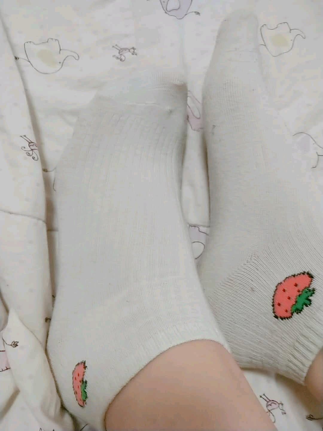 Close-up of stockinged ankle sliding over bare skin with a soft, teasing motion