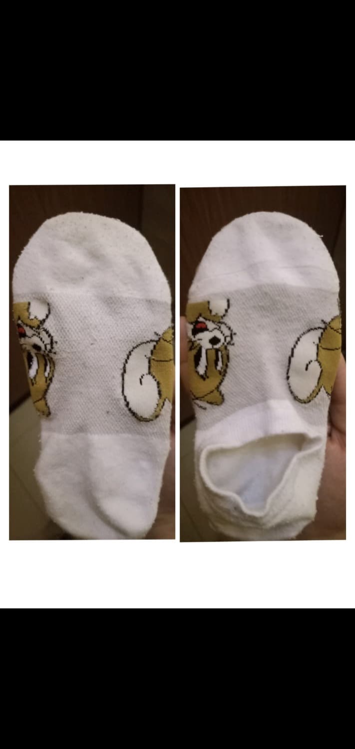 Sunlit feet resting on a balcony ledge, damp cotton socks clinging to toes with sandals pushed aside