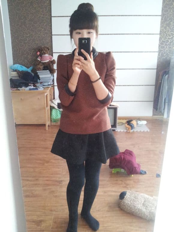 Legs in sheer pantyhose stretched toward winter sunlight, soft shadows accentuating the arch and calf