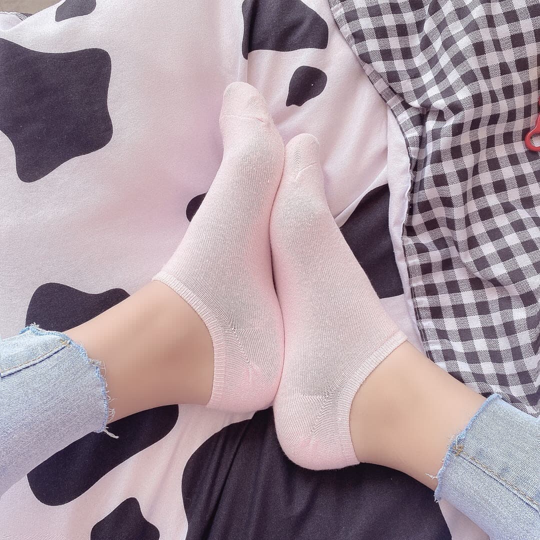 Side view of feet slipping out of sheer stockings, toes relaxed, skin smooth with a gentle shadow