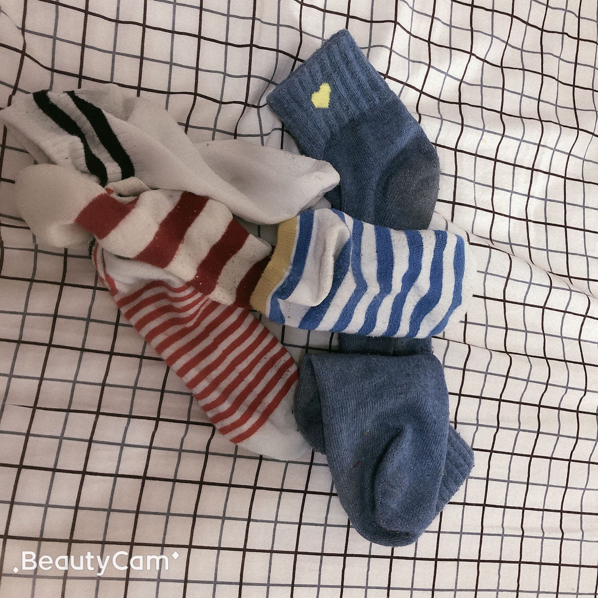 Three options displayed: sheer nylons, cozy cotton socks, and bare soles arranged on soft fabric for comparison