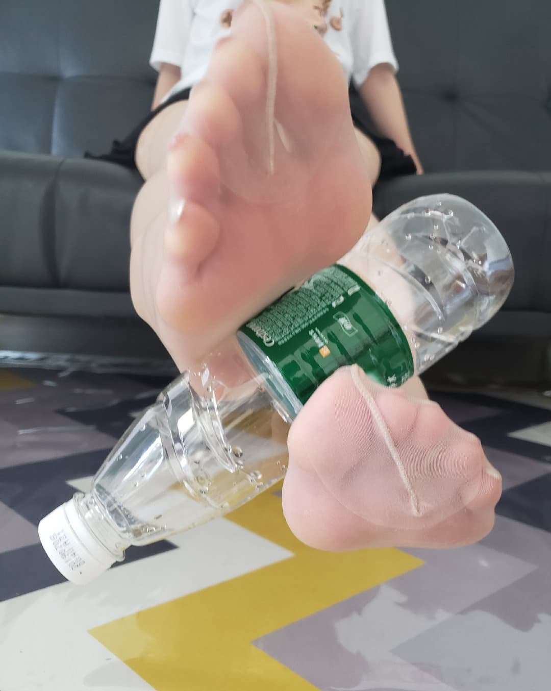 Delicate off-white stockings covering a foot, fabric slightly translucent and softly cradling the arch