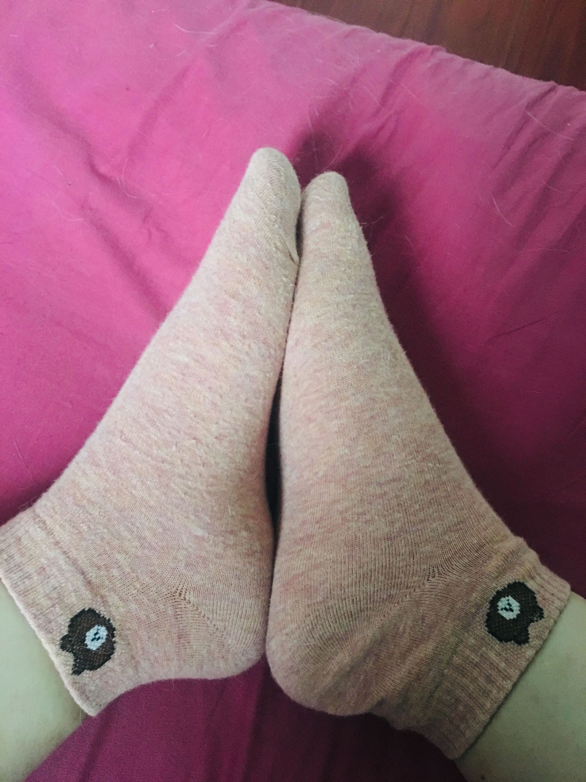 Tight crop of a foot in stocking, toes slightly curled and seam drawing the eye down the leg