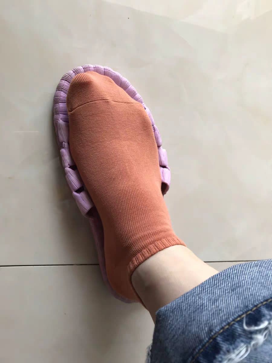 Cropped shot of girlfriend’s foot in sheer stocking, ankle exposed and toe crease visible in soft light