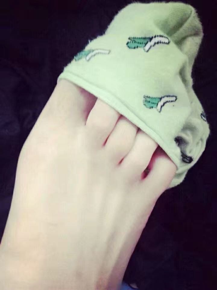 Newcomer’s feet in delicate sheer stockings, toes peeking out near a soft blanket edge