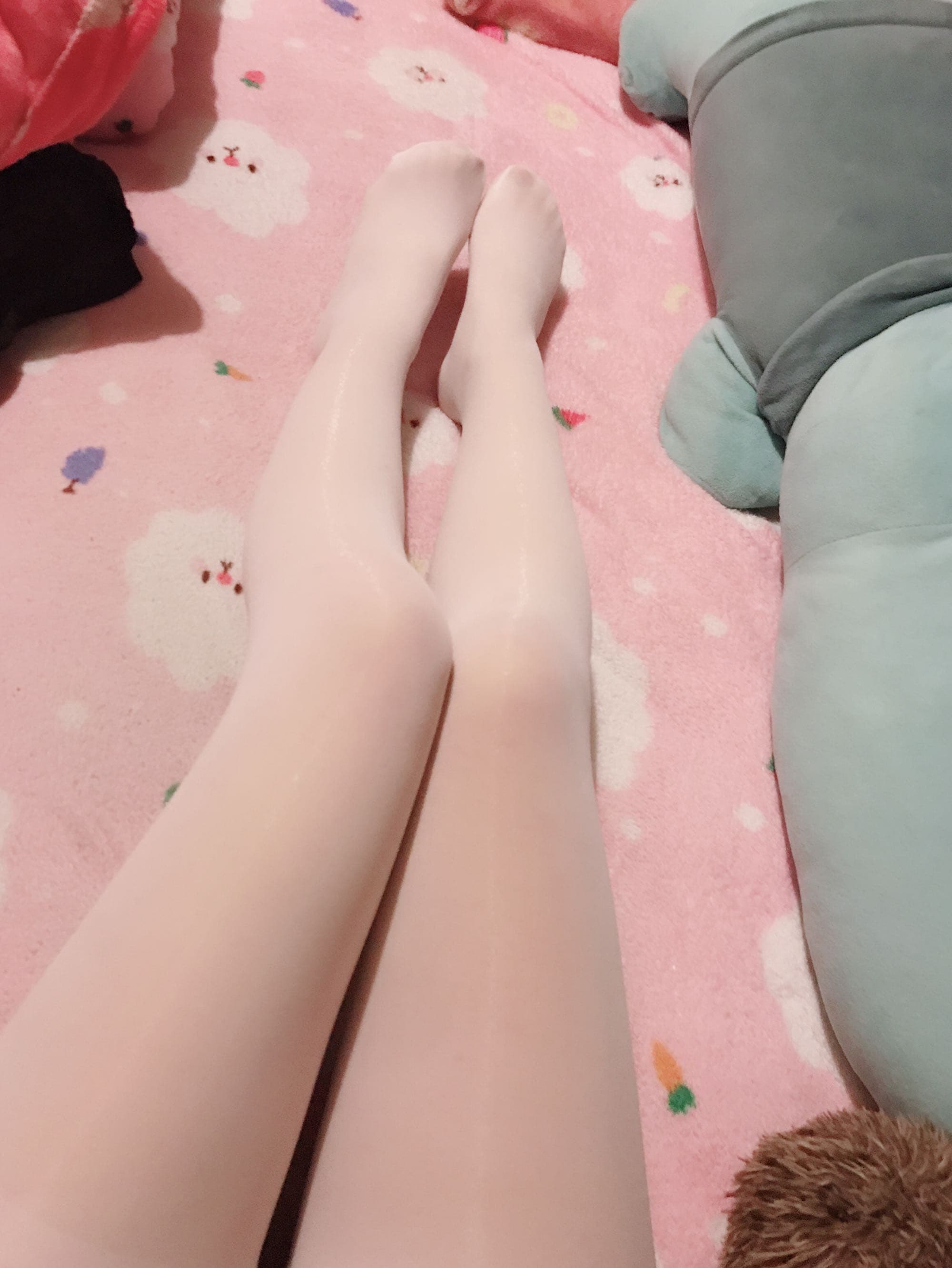 Partial view of foot sliding from sock cuff, ankle skin warm and slightly flushed in soft light