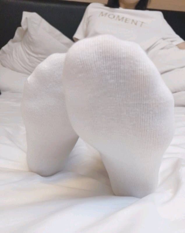 Portrait of a newcomer’s exposed soles and sheer stockings, shy toes flexing in a softly lit studio setting