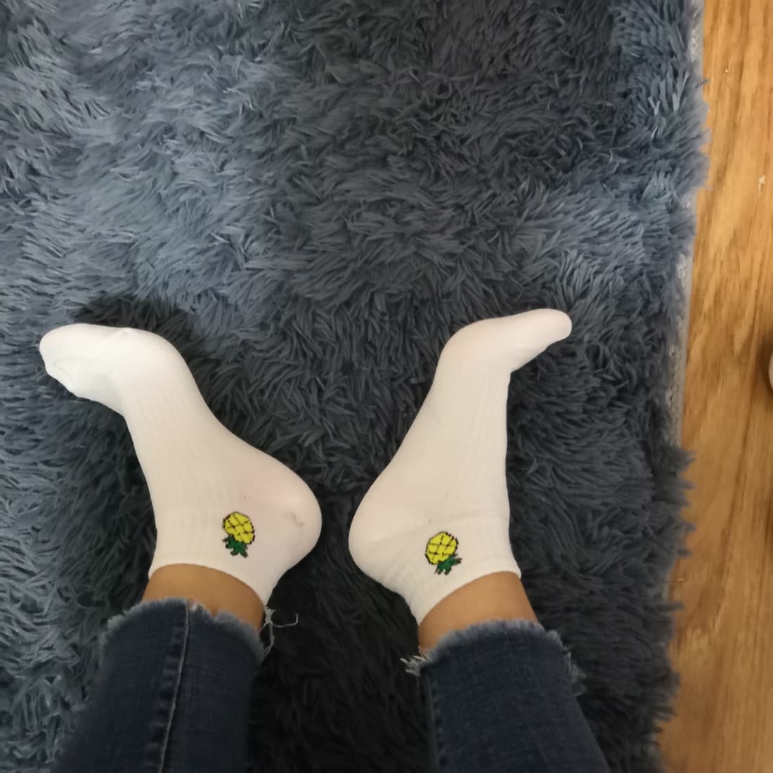 Close-up of arched bare foot resting on silky bedsheet, toes slightly curled in soft light