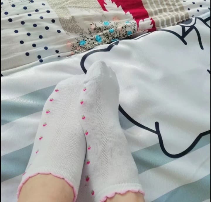 Warm close-up of feet in soft cotton socks with visible texture and relaxed, cozy fit