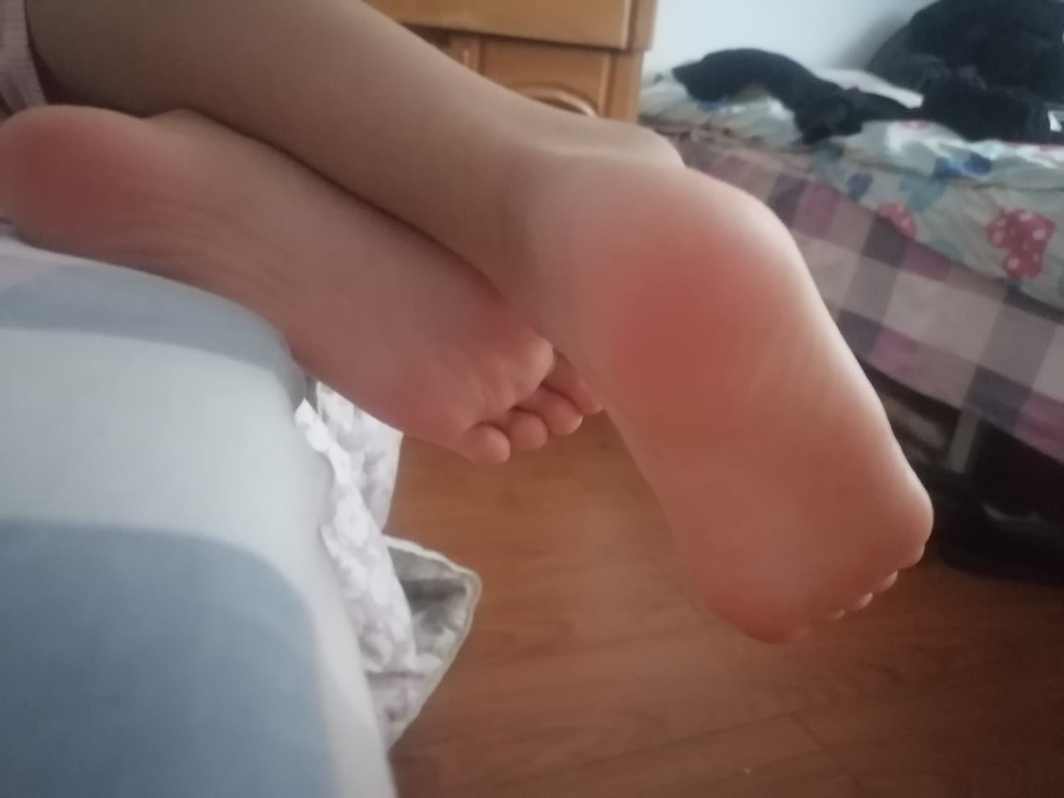 Alluring companion’s bare feet in sheer stockings