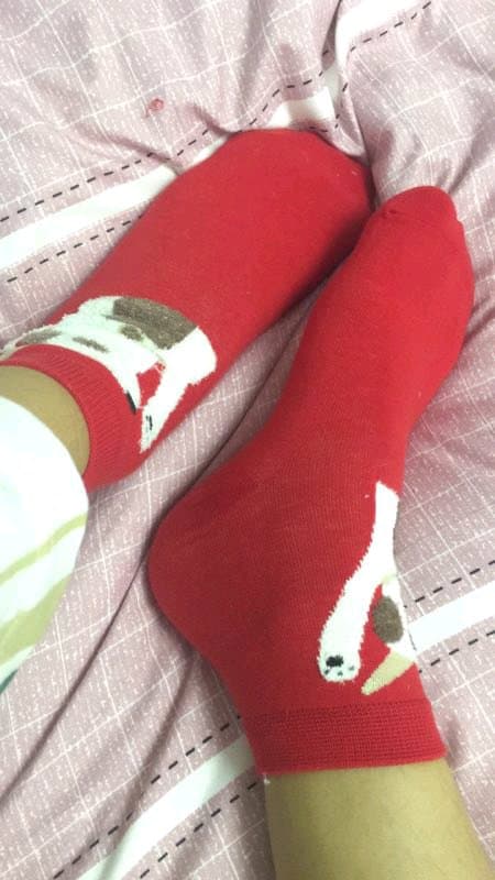 Invitation-style photo of a bare sole and stocking-clad foot, intimate angle with soft background