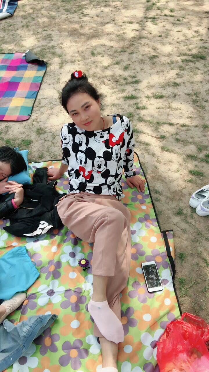 Close-up of nylon-clad arch and curled toes under dramatic lighting, glossy stocking texture visible