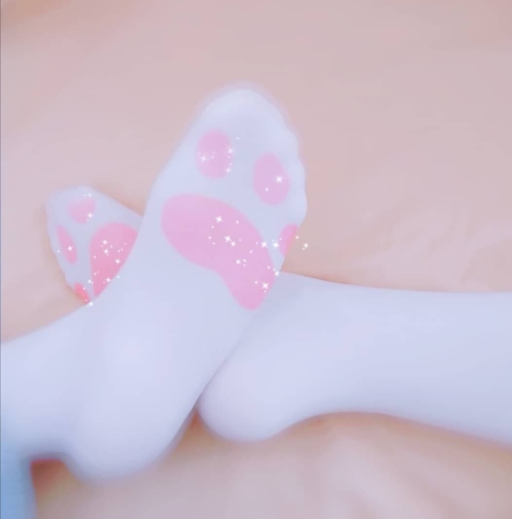 Frontal view of neat, bare toes and a small arch resting on soft fabric, radiating playful confidence