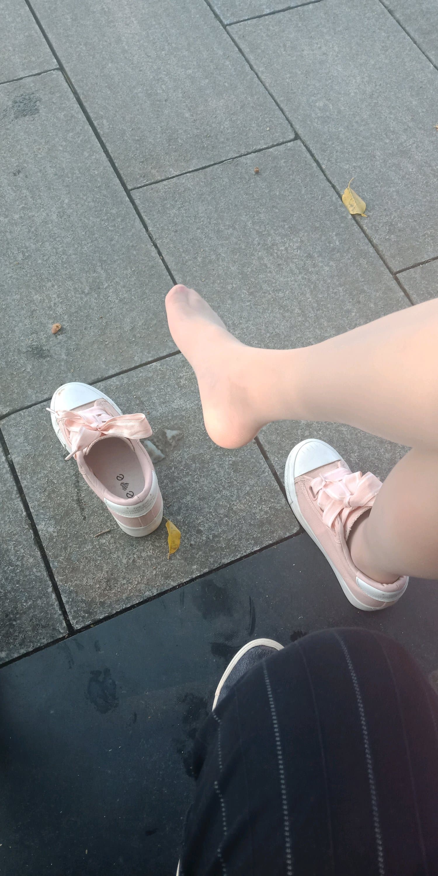 Bare feet freed from nylons and socks, toes splayed with visible creases and a cool, relaxed sole