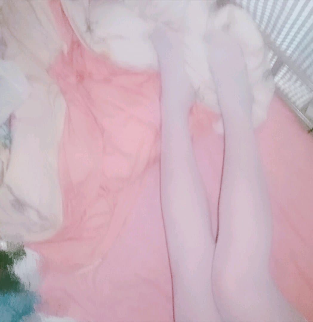 Long legs clad in sheer stockings with a glimpse of bare toes, emphasizing silhouette and silky texture