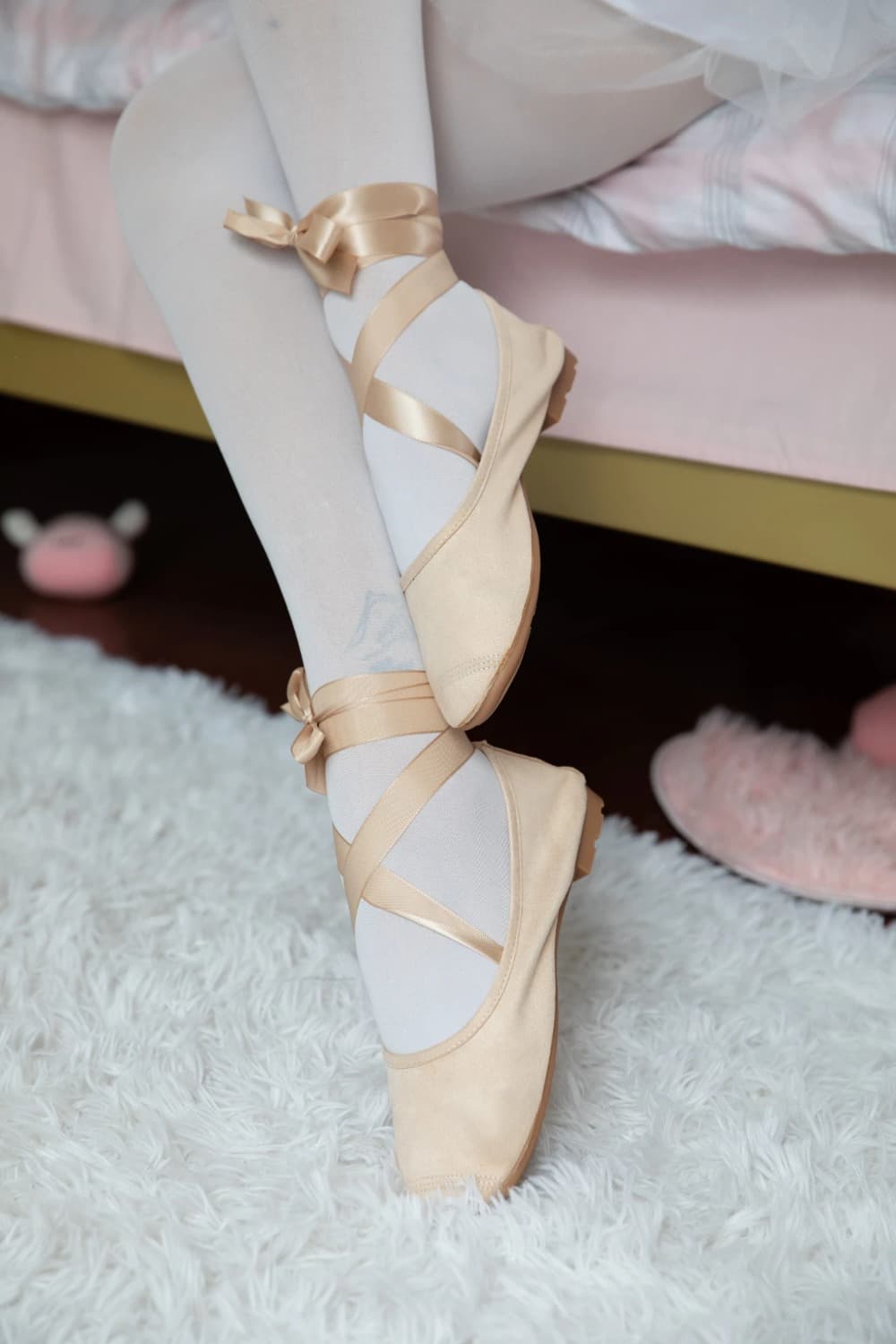 Close image of silk-covered toes peeking from smooth fabric, hinting at delicate skin beneath