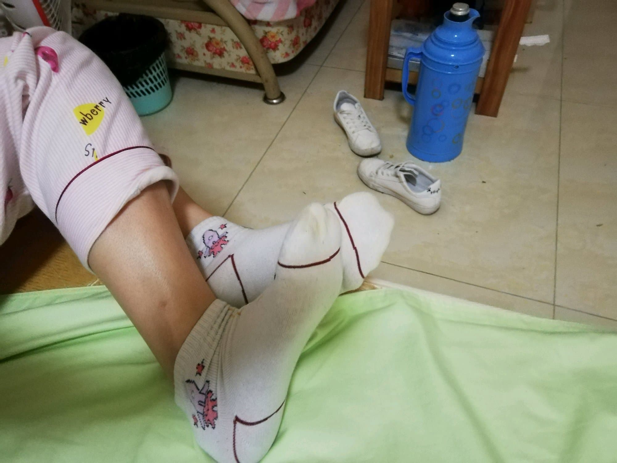 Ankle with rolled stockings and bare toes peeking through, soft home lighting