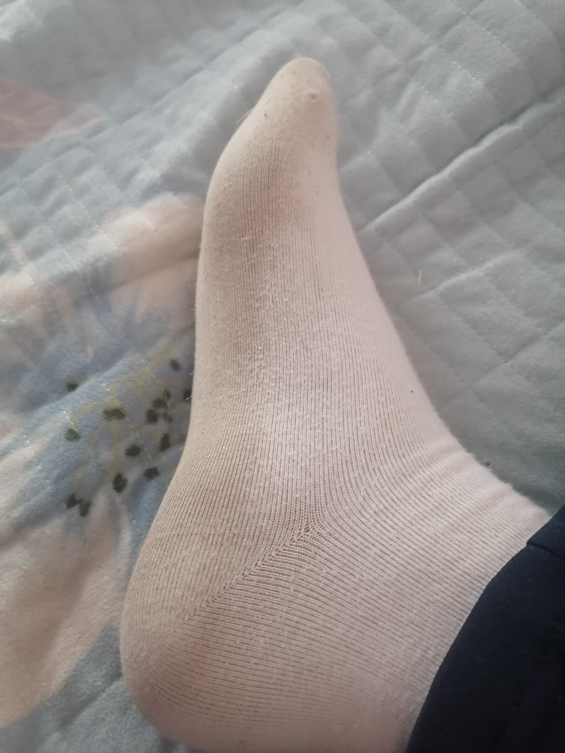 Close shot of a hand gently washing a dirty sole, water beads glistening as grime is carefully removed from the arch