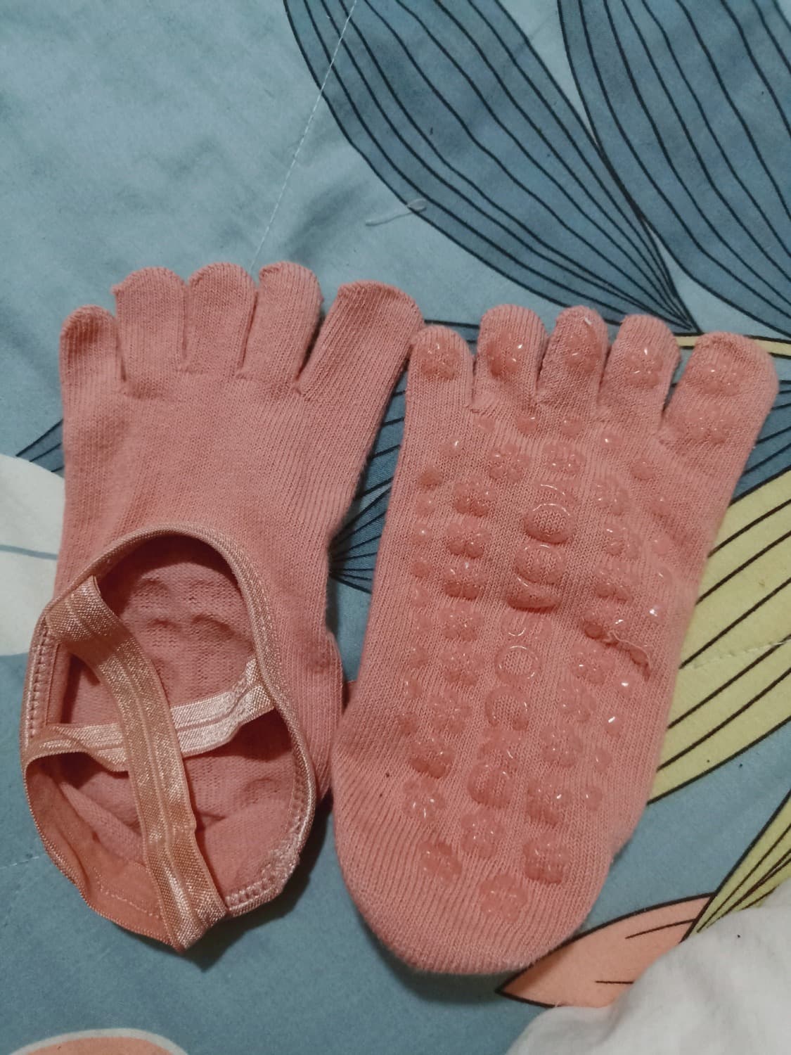 Freshly laundered cotton socks draped over a clothesline, sunlight highlighting soft texture and clean fibers