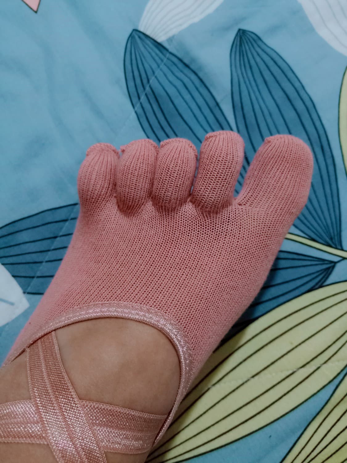 Pair of clean socks folded on a wooden table, suggesting soft cotton warmth and a faint lingering scent