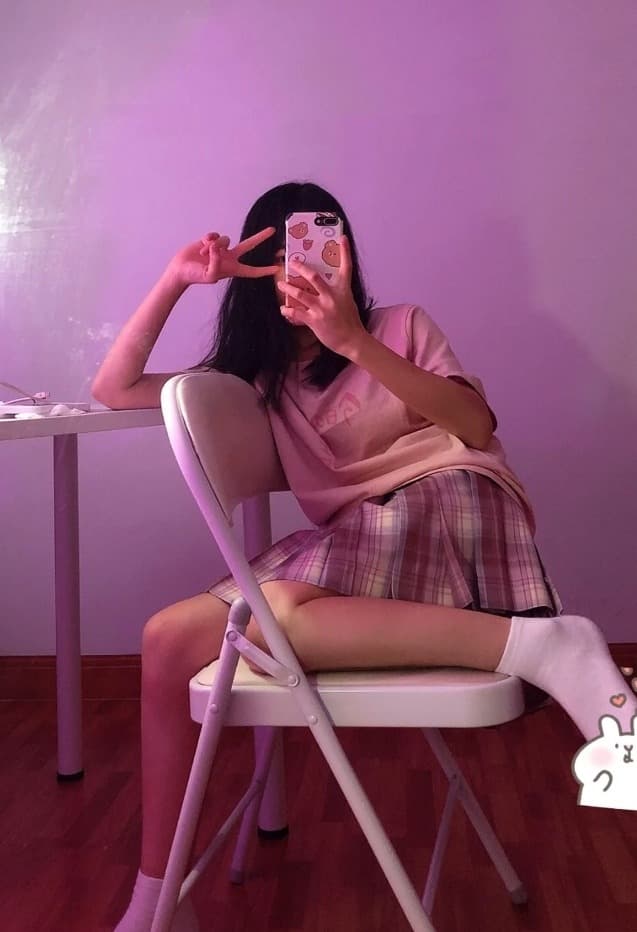 Bare feet on a plush carpet with a single stocking half-drawn over one ankle, suggesting playful idleness