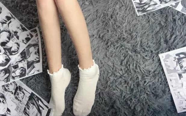 Seductive composition of partially removed sock around ankle, revealing smooth skin and a hint of toe separation