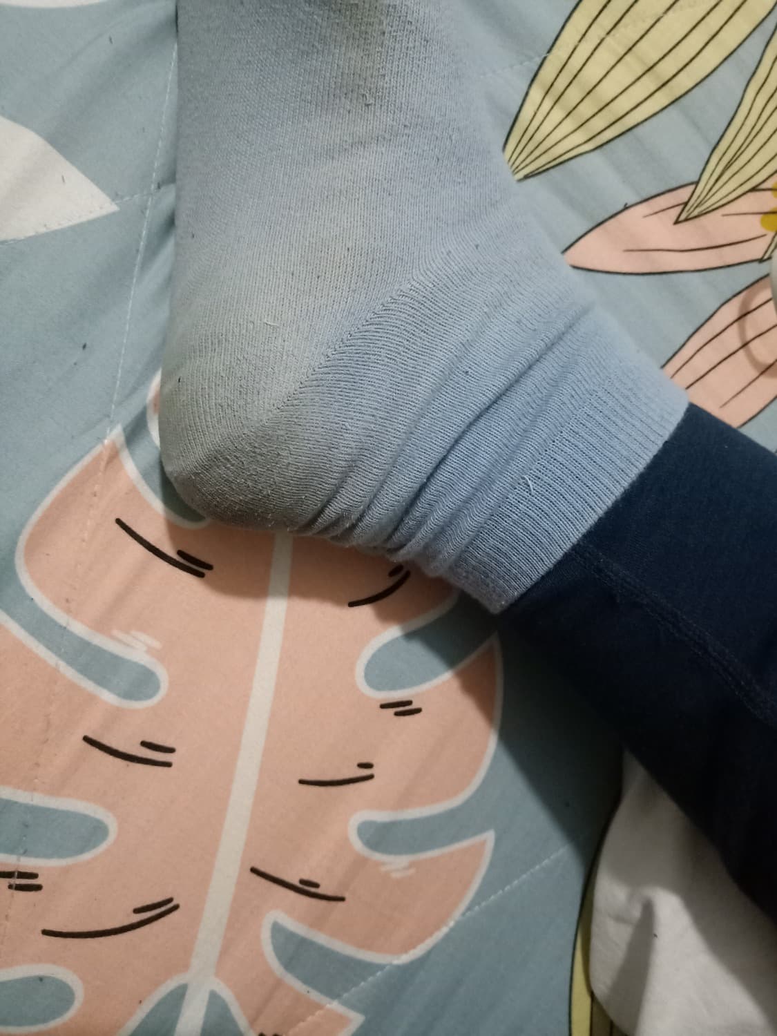 Close-up of sock fabric clinging to toes, showing texture, slight sheen from wear, and cozy, intimate creases