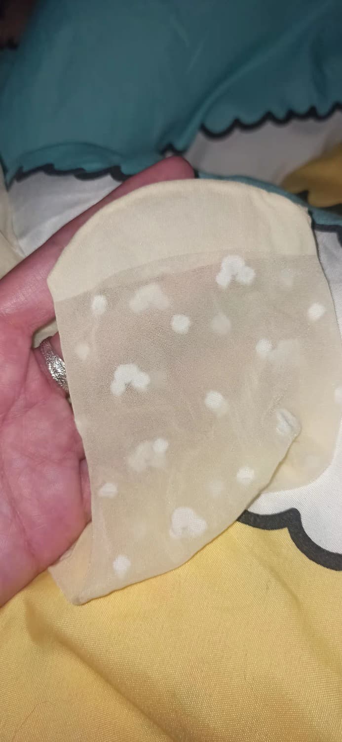 Close view of soft cotton socks stretched over toes with subtle heel wear and gentle fabric texture visible