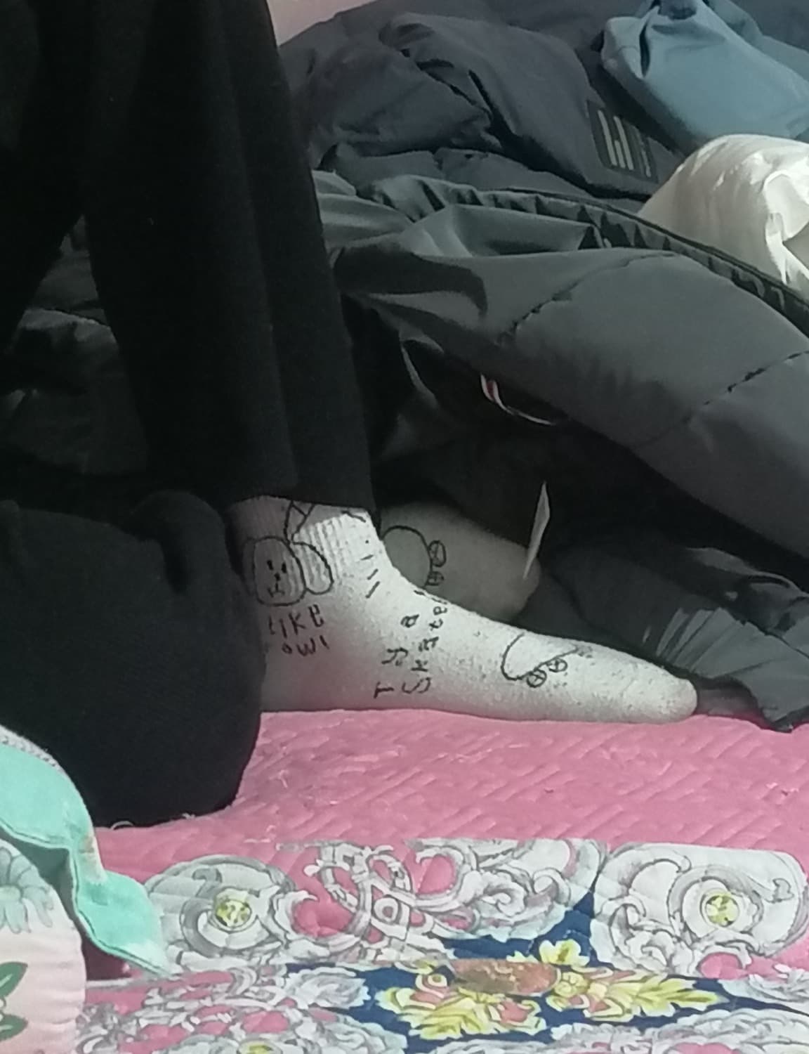 Her feet posed gracefully with sheer stockings partially rolled down, arch emphasized