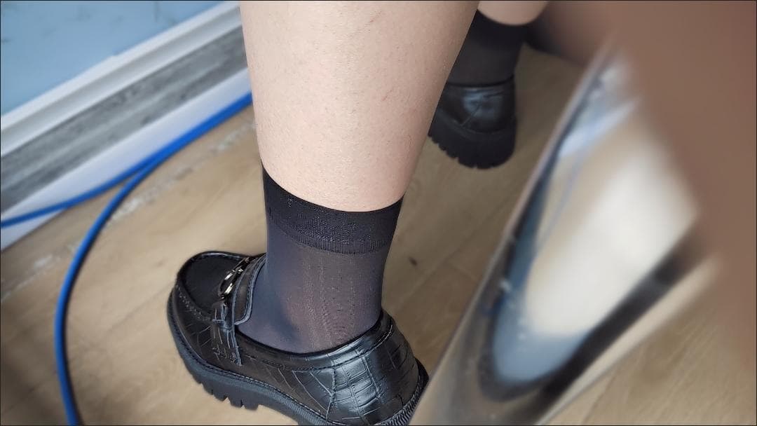 Short silk stockings ending at the calf, lace trim visible above a bare ankle