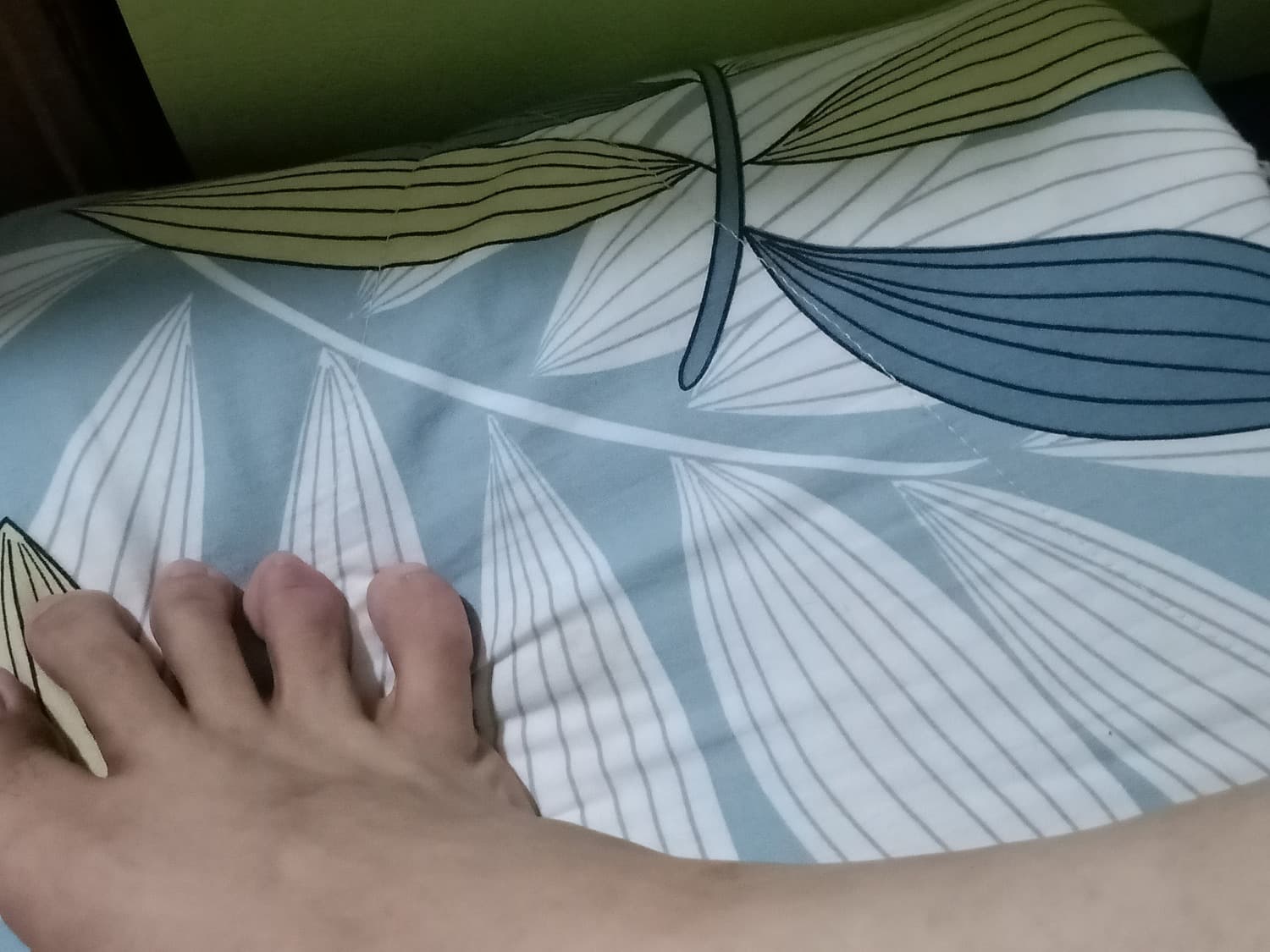 Close view of nylon-clad toes curling, hinting at warmth and private intimacy