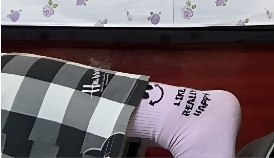 Soft pink cotton socks clinging to small feet, slightly rumpled at the ankle