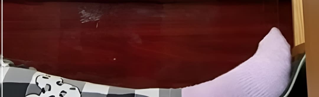 Rolled pink socks revealing toe tips and the gentle curve of the arch