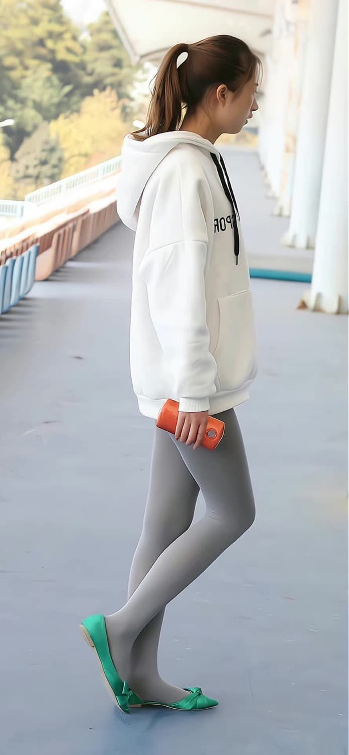 Grey silk stockings on slender legs with one ankle exposed, hinting at playful secrets