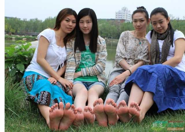 Close-up of seasoned foot arch and toes in half-removed nylon, evoking experienced, confident sensuality