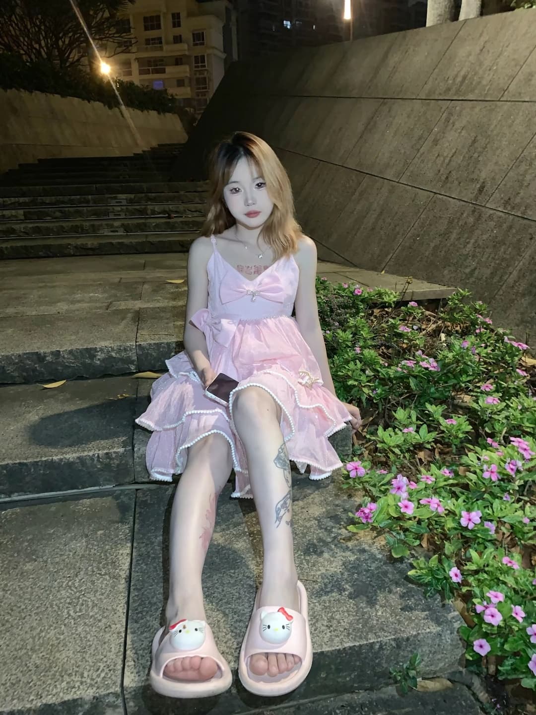 Soft pink slippers half off bare feet, toes playfully exposed, stocking hem slightly rolled, cozy indoor setting with warm lighting