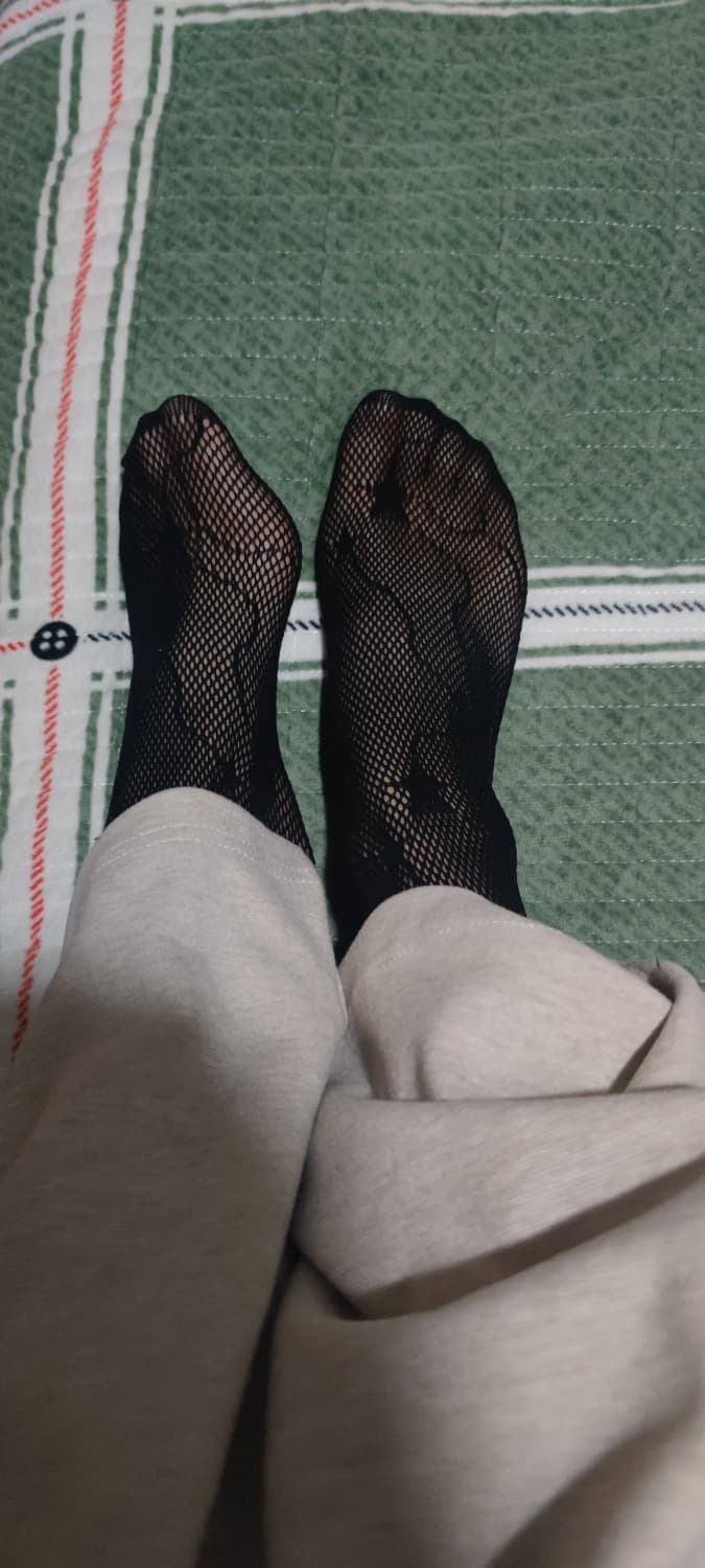 stockinged ankle by chair leg